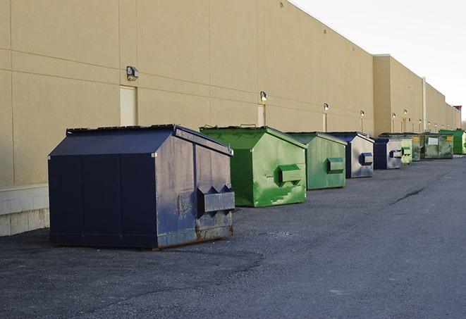 a row of blue construction dumpsters on a job site in Buchanan